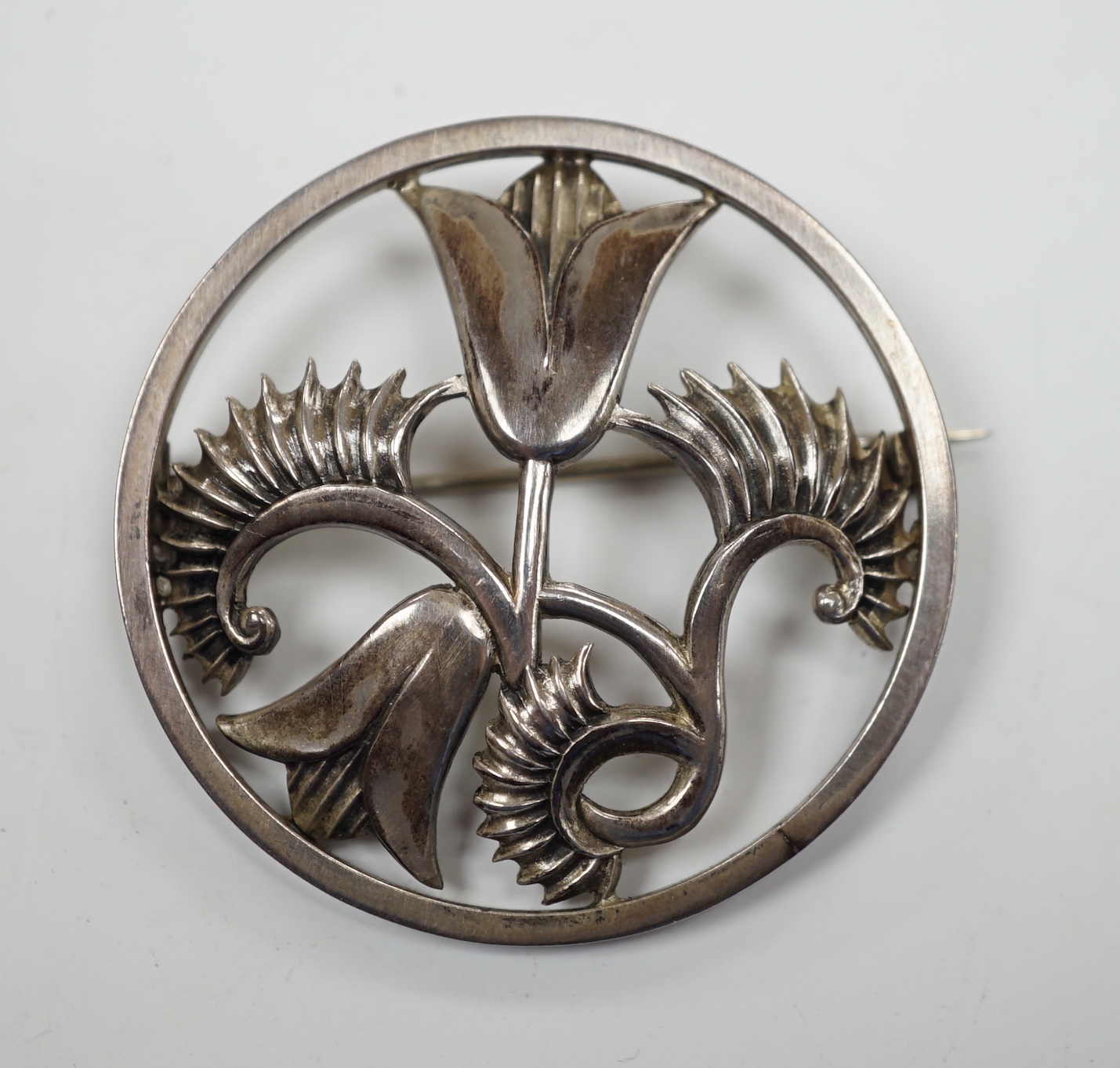 An Elizabeth II Geoffrey G. Bellamy for George Tarratt Ltd silver circular 'flower and fern' brooch, no. 164, Birmingham, 1961, 43mm.